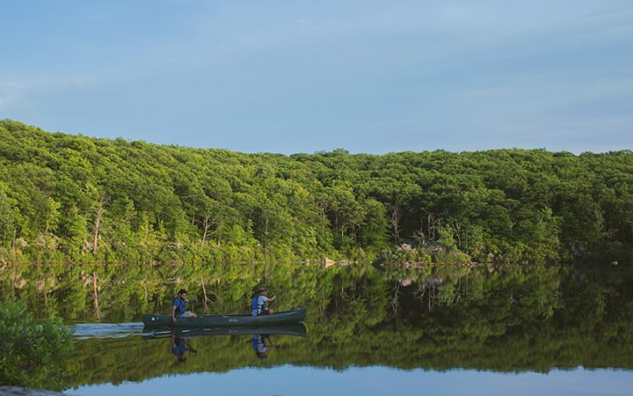 Canoeists on Breakneck Pond at the Stephen & Betsy Corman AMC Harriman Outdoor Center.