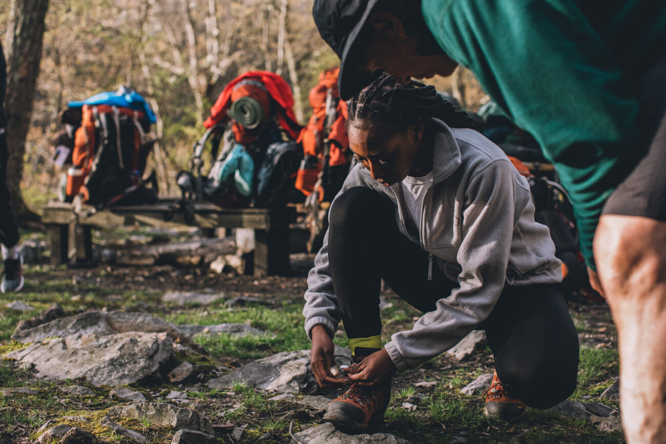 Woman adjusting hiking boot
