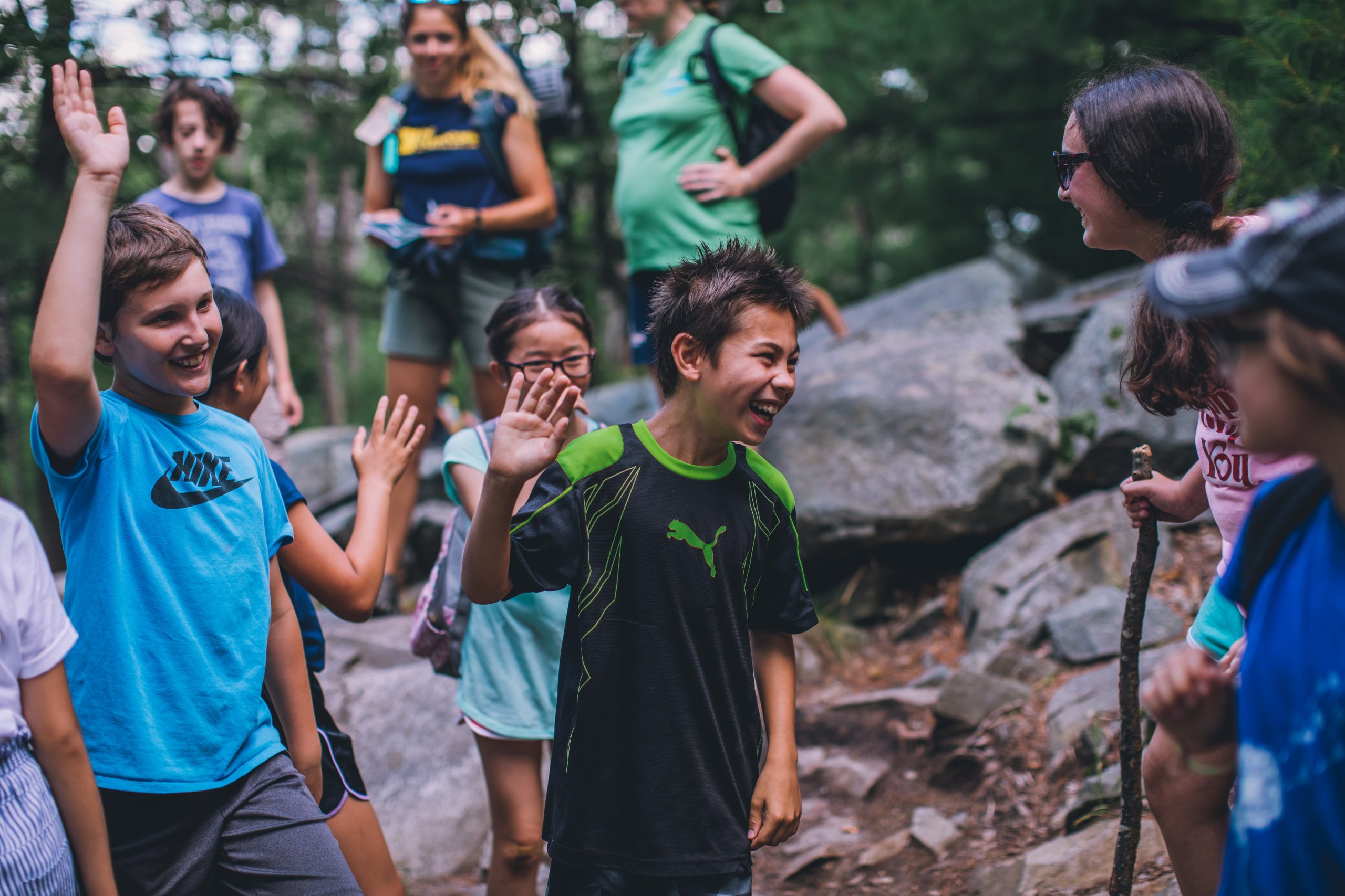 Kids smiling and playing outdoors.