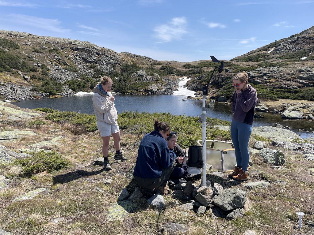 Research Team doing Alpine Garden Transects in front of a mountain lake.