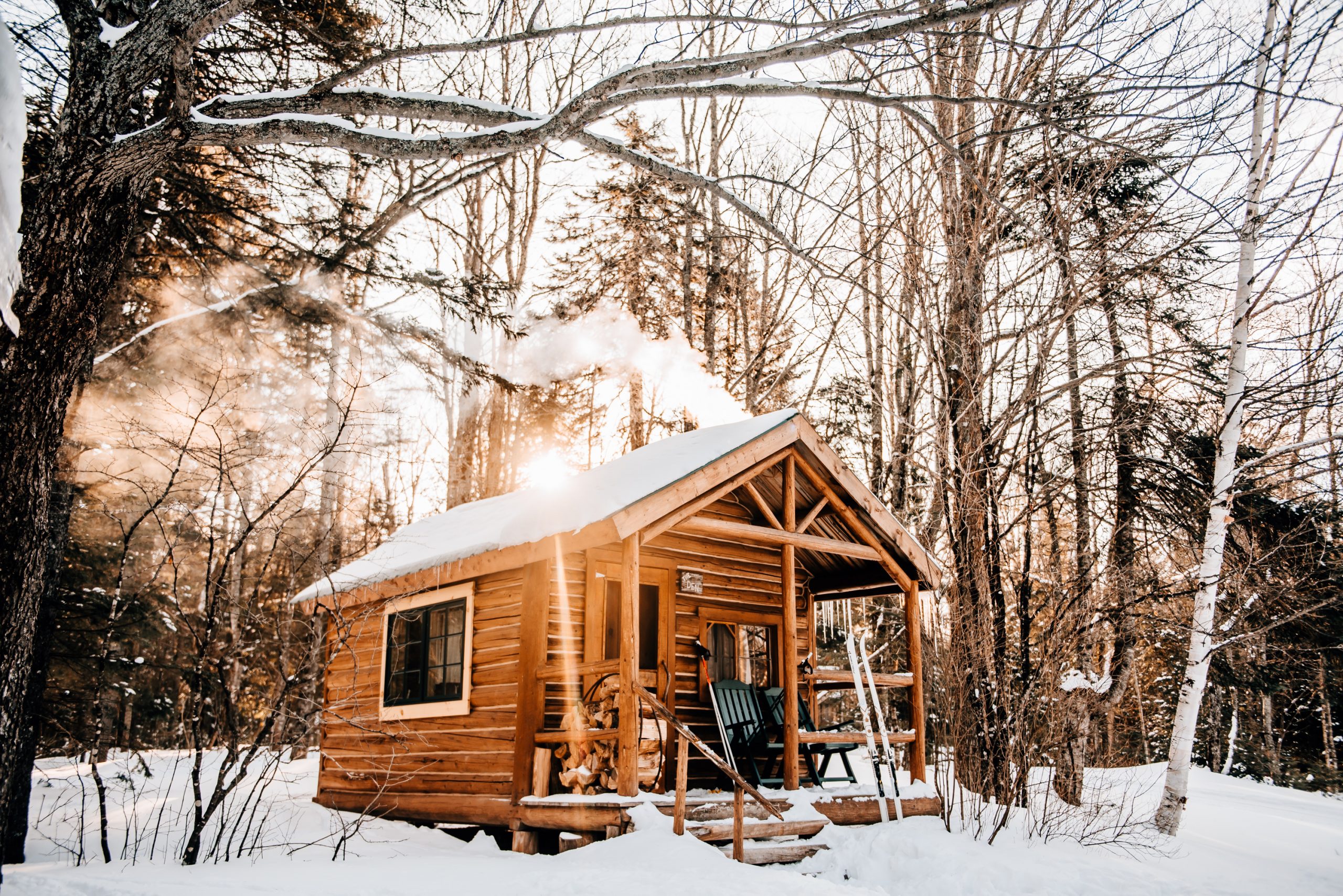Snowy cabin with skis outside.