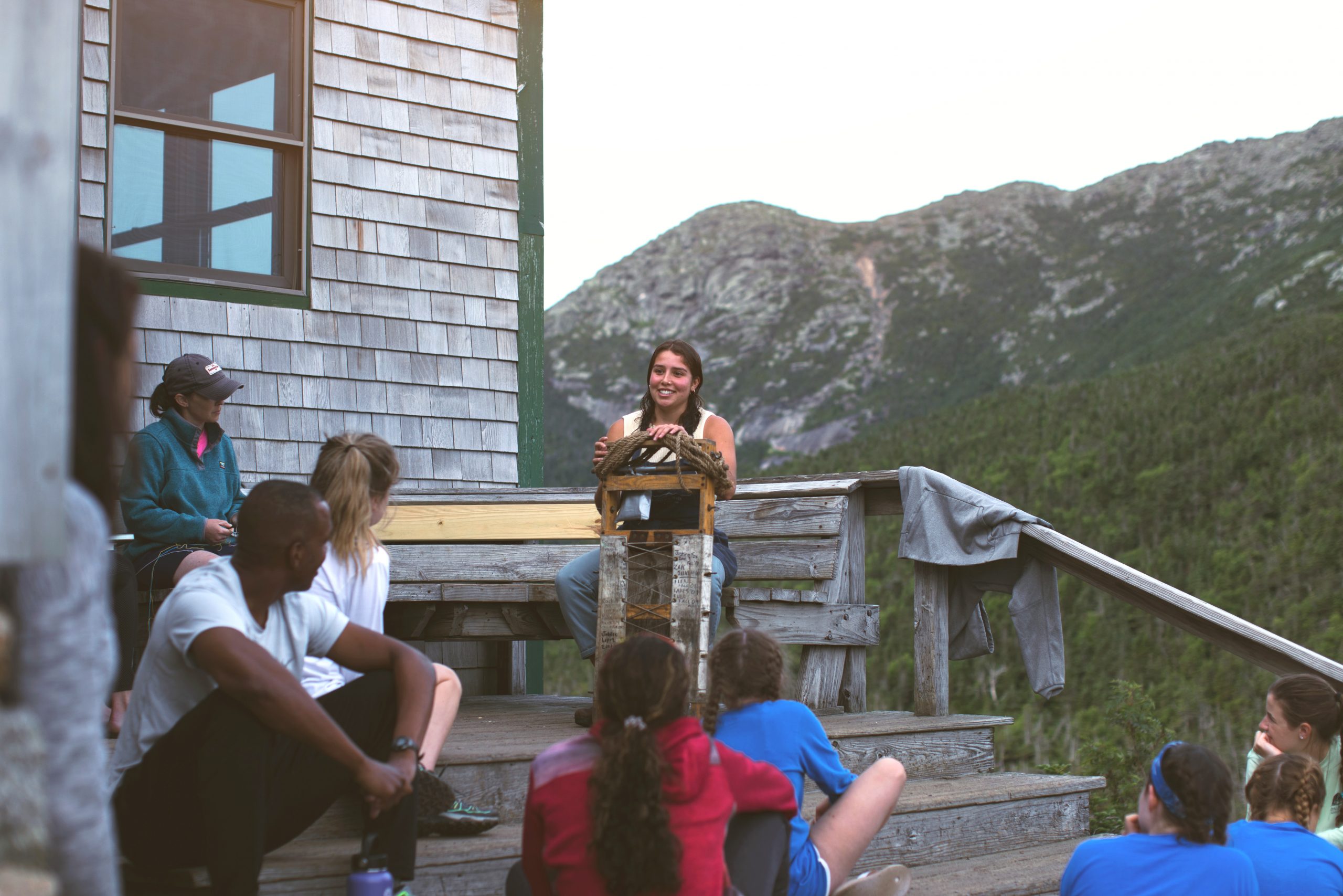 Jul. 30, 2018. AMC Greenleaf Hut, (Franconia Range), White Mountain National Forest, New Hampshire-- Photo by Paula Champagne. Hut croo talks to guests on the porch of greenleaf hut
