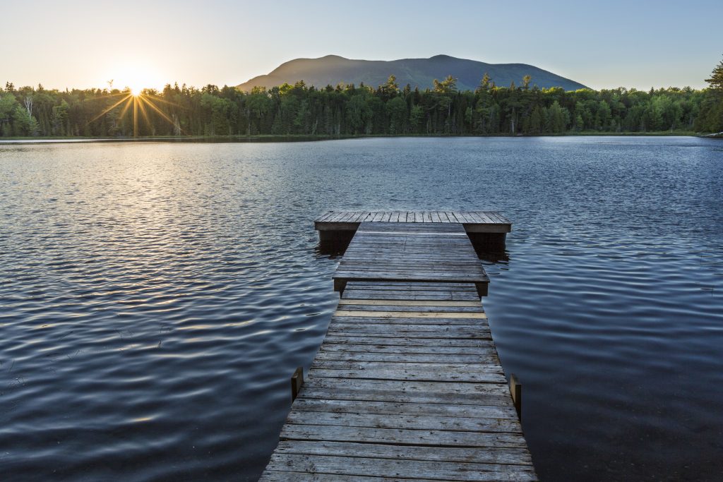 The Sun Sets Behind Baker Mountain As Seen From The Dock On Little Lyford Pond In Maine's 100 Mile Wilderness Near The Appalachian Mountain Club's Little Lyford Lodge.
