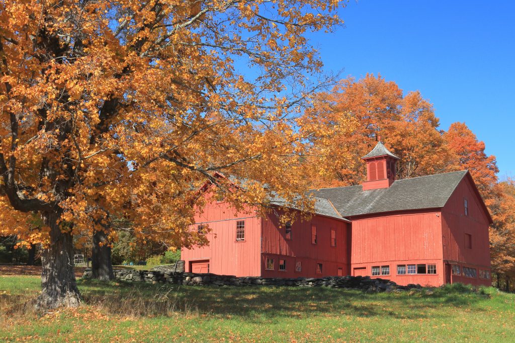 Red barn against a blue sky.