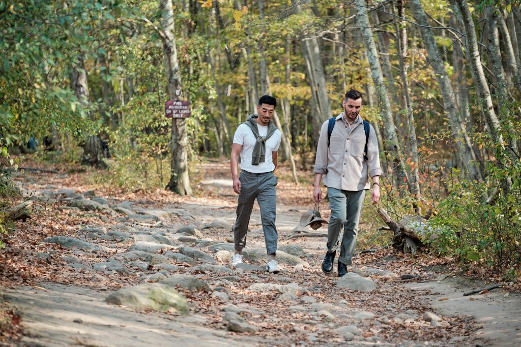 Two men walking in fall.