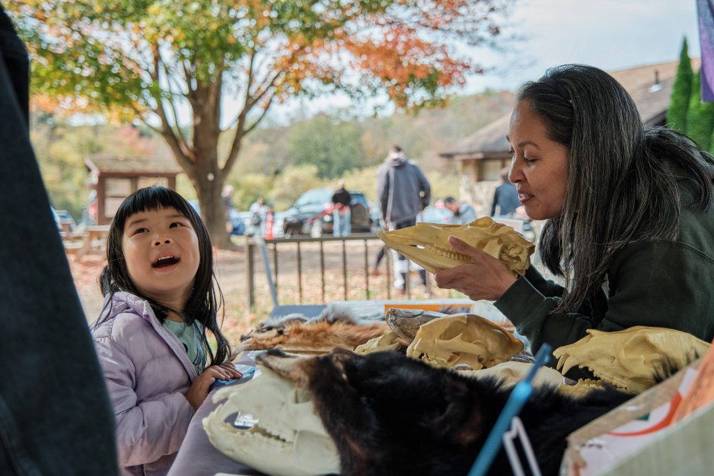 Child and mother looking at skulls.