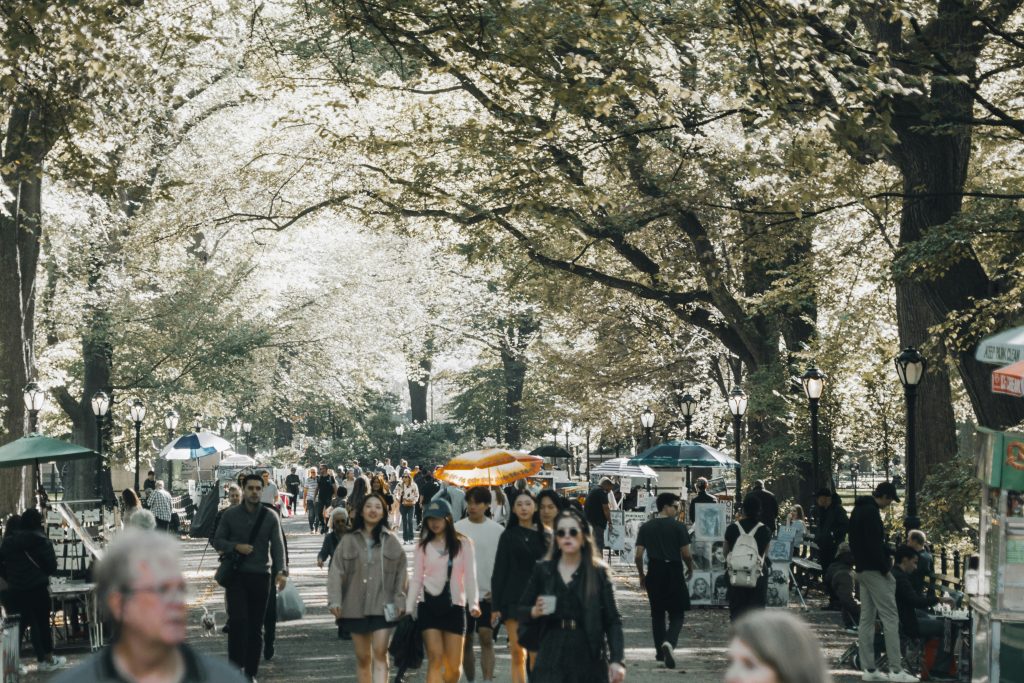 People bustling through a busy downtown scene in NYC.