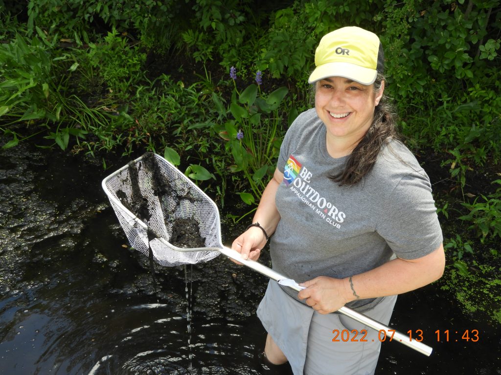 Sarah Nelson holds a net and smiles.