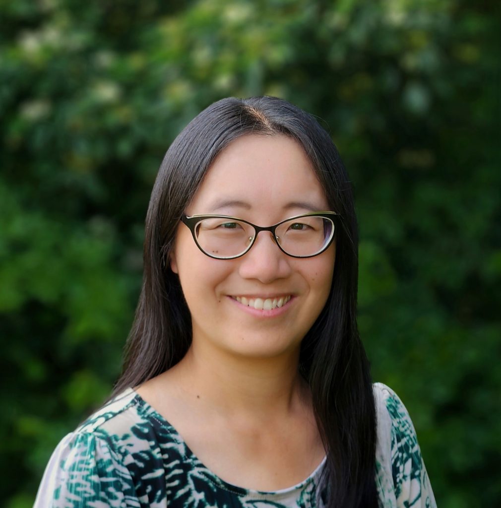 Hannah Clipp, smiling with a background of trees.