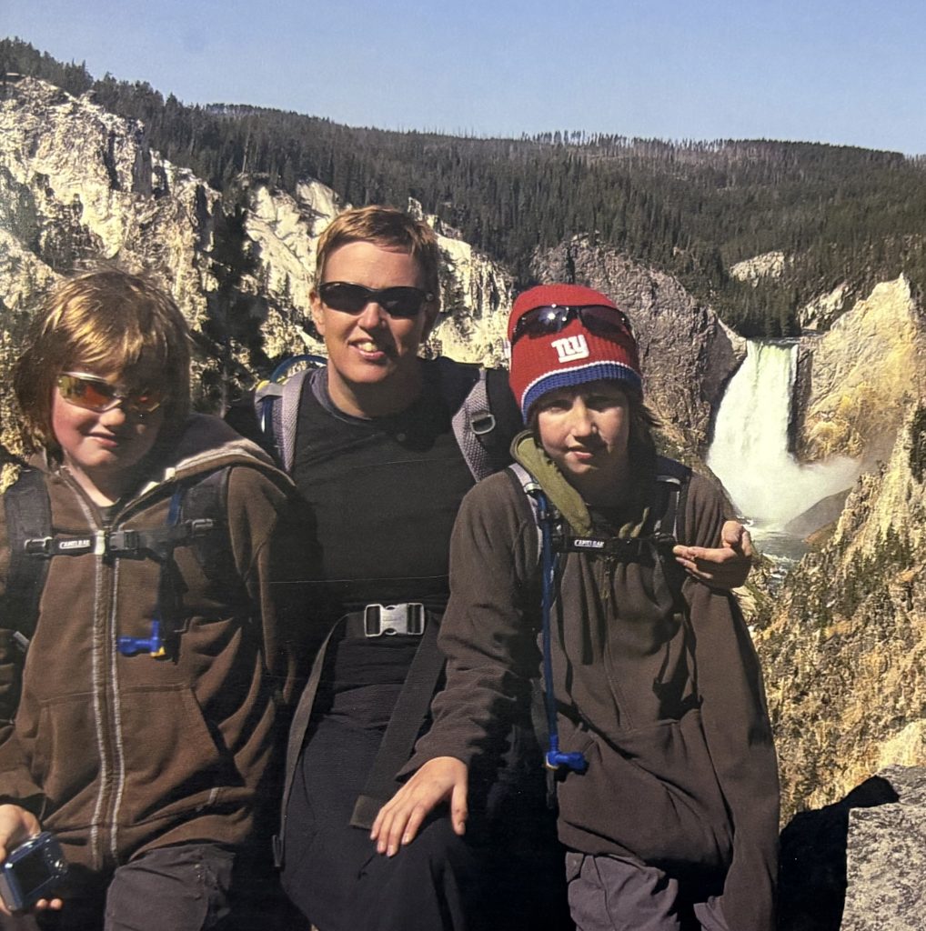 Jeannette Balantic and her two boys in front of a large waterfall.