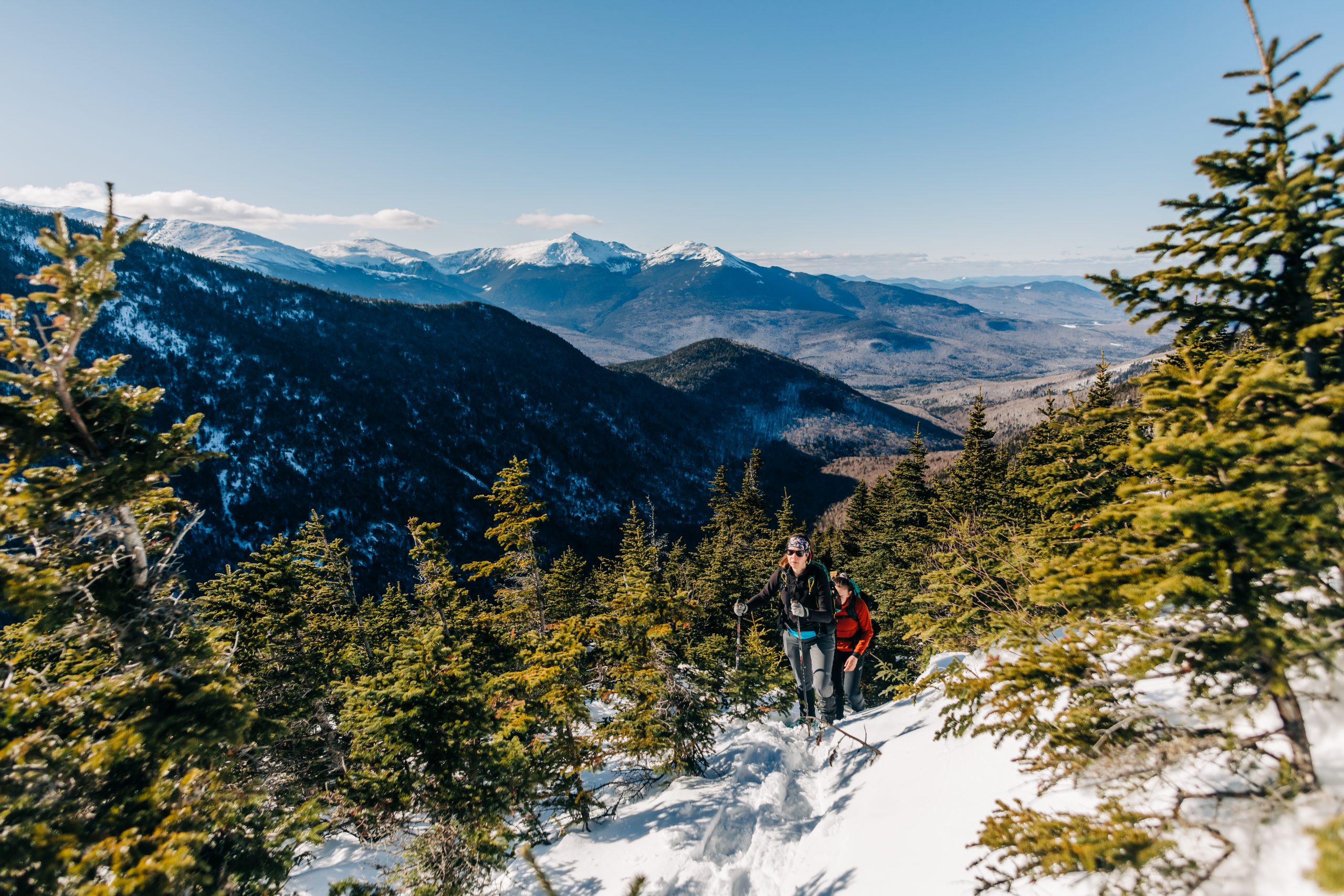 Mar. 18, 2023. Carter Dome, Carter-Moriah Range, White Mountain National Forest, New Hampshire-- Wildcat Mountain is in the midground, the Presidential Range is in the background. An AMC staff-led guided program. Photo by Corey David Photography. Corey David Photography