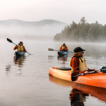 3 people kayaking in foggy lake