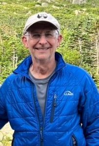 David Agneta smiling in a blue jacket.