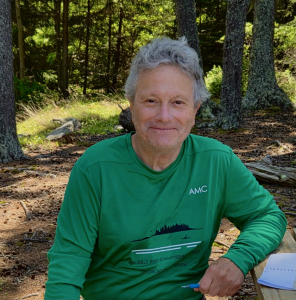 Frank Polito wearing a green shirt in a coastal forest.