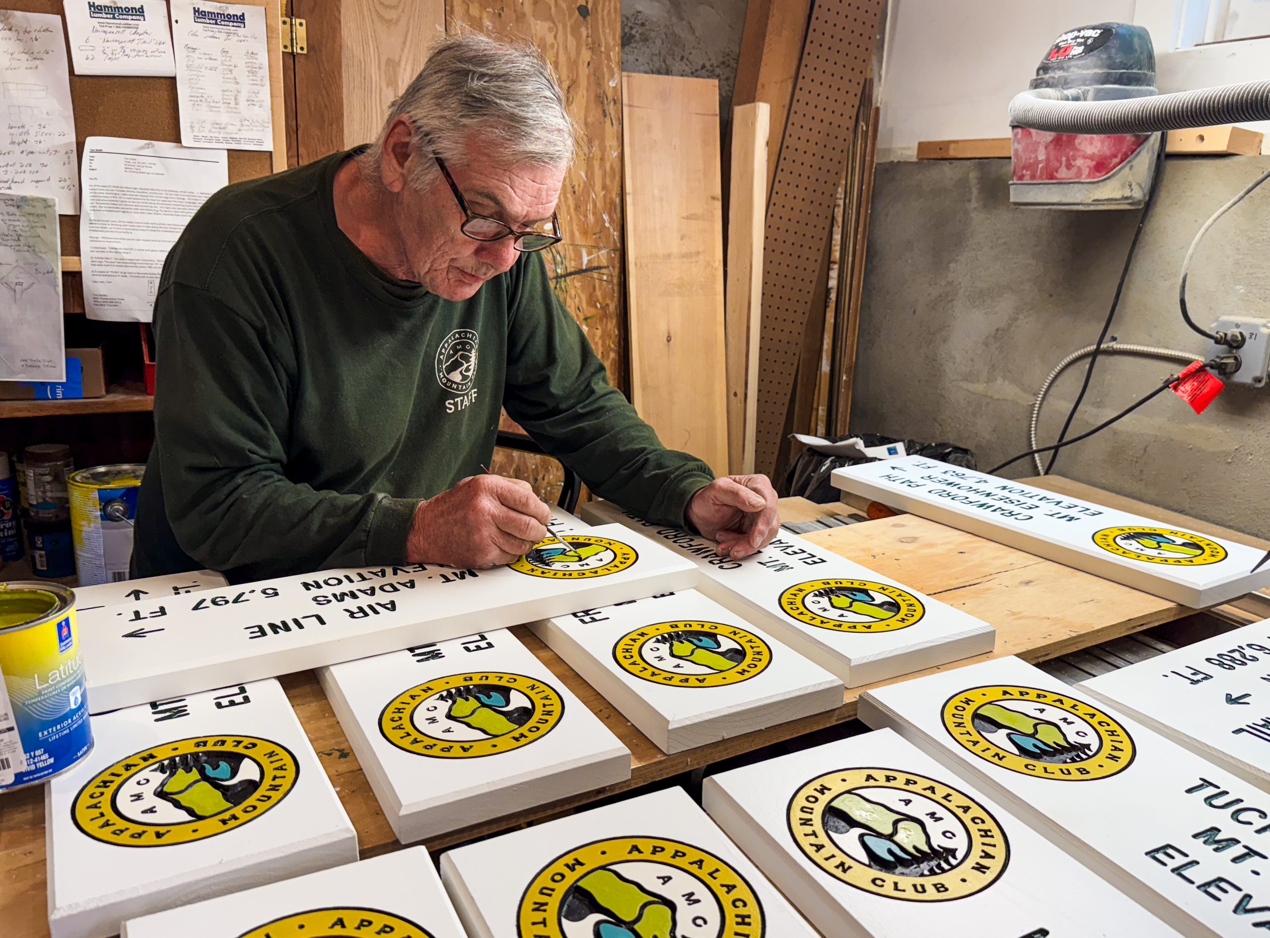 George Brown leans over his hand-painted signs.