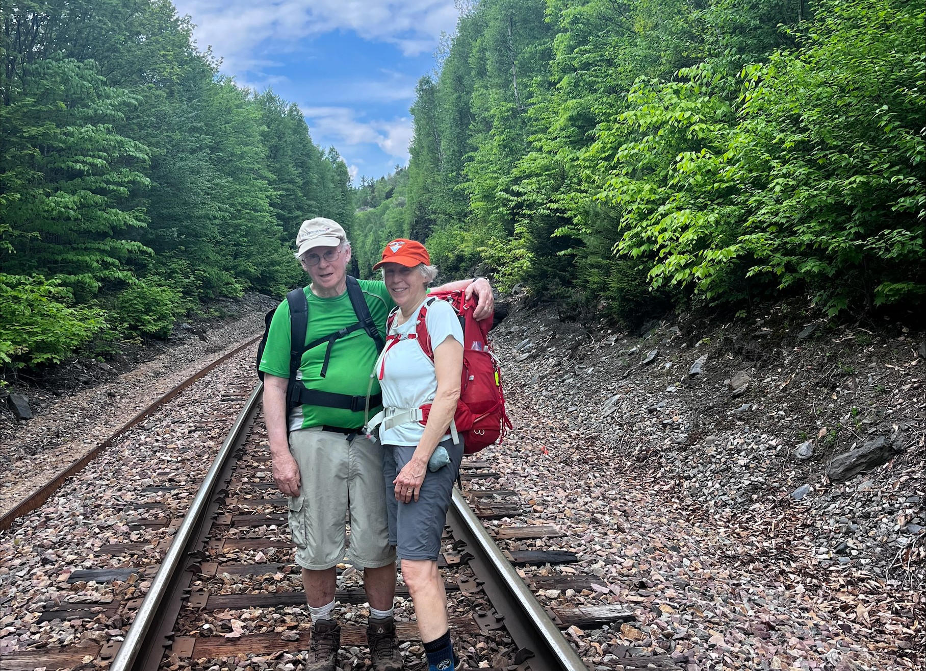Ed Kane and Marty standing on a railroad track