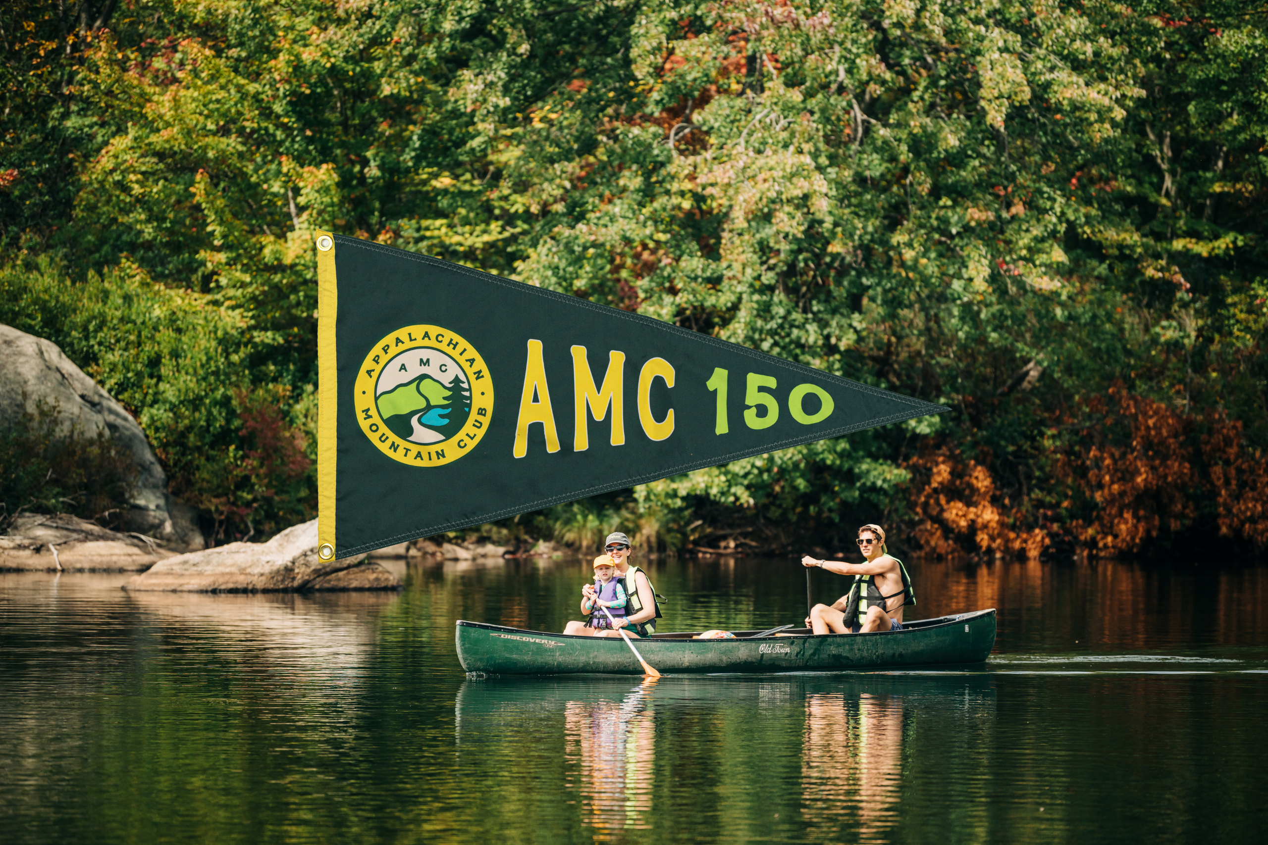 3 people paddling at corman harriman outdoor center