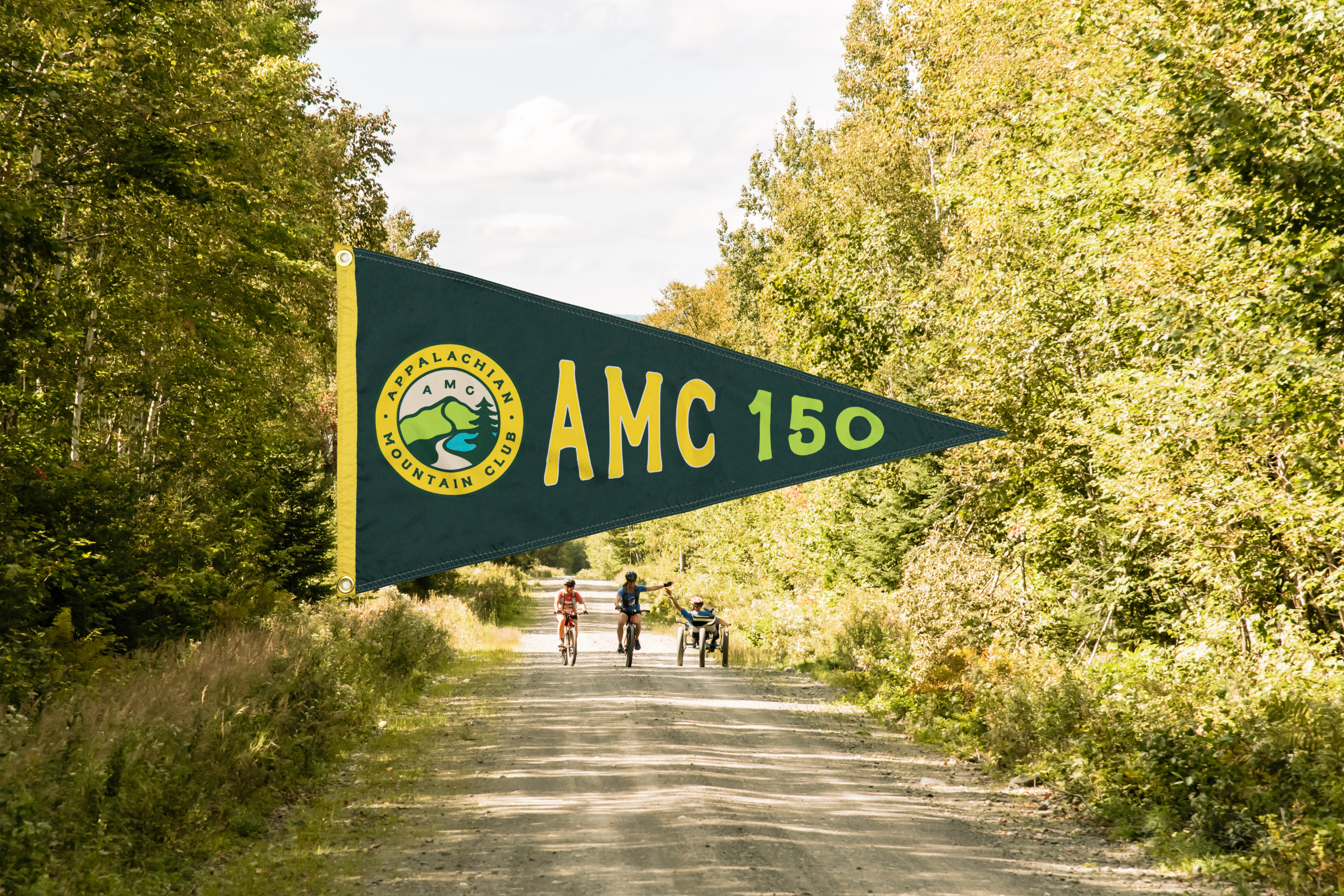3 people biking on gravel road