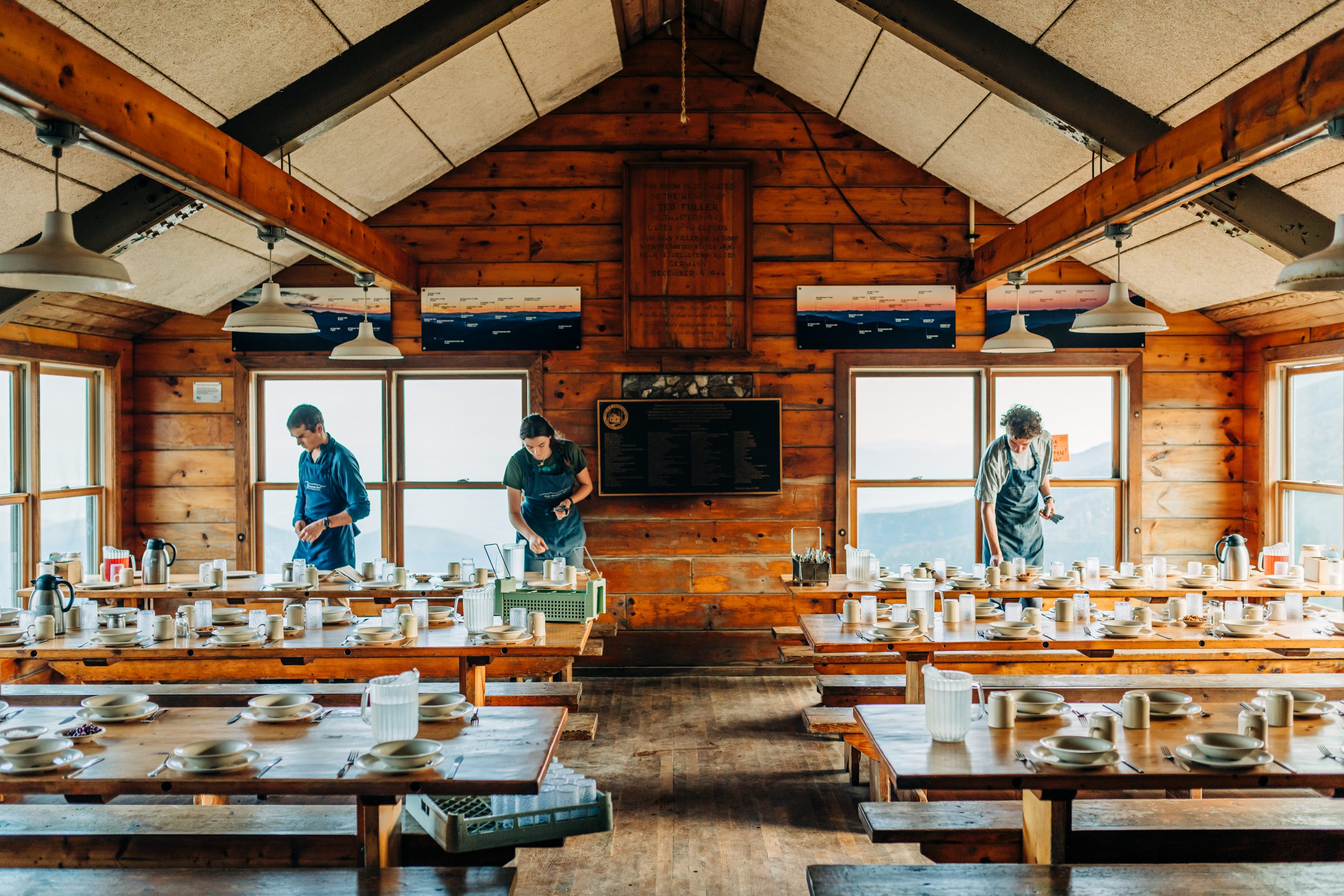 A Hut Croo sets the tables in the Lakes of the Clouds dining room.
