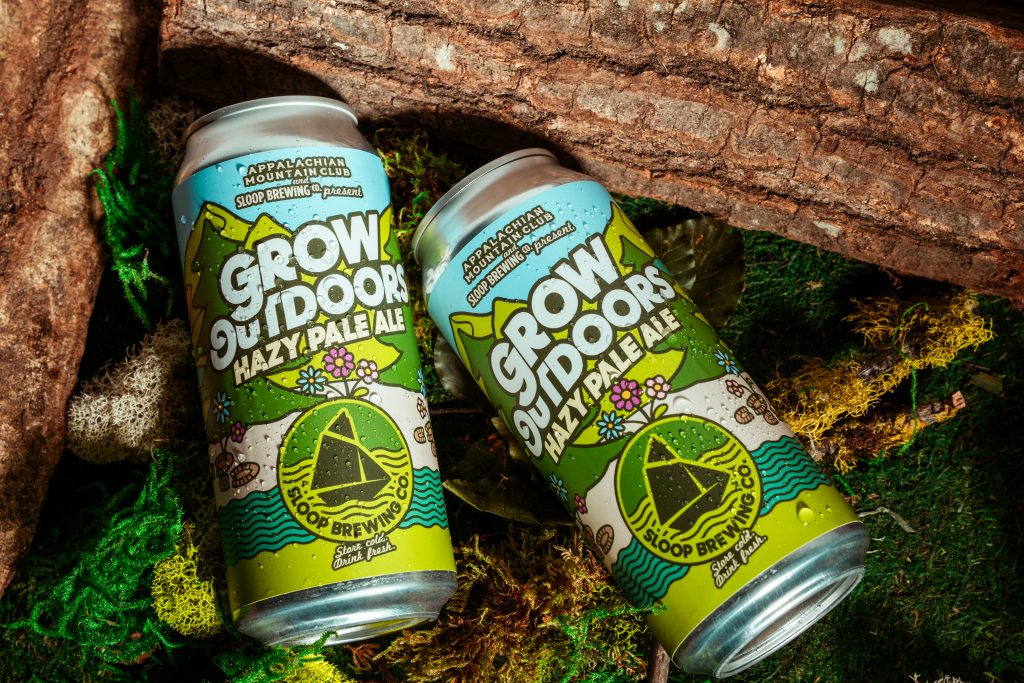 close up of AMC x Sloop Grow Outdoors Hazy Pale Ale beer cans