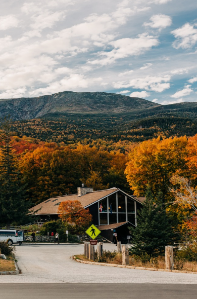 pinkham notch visitors center in fall foliage with clear view of mount washington